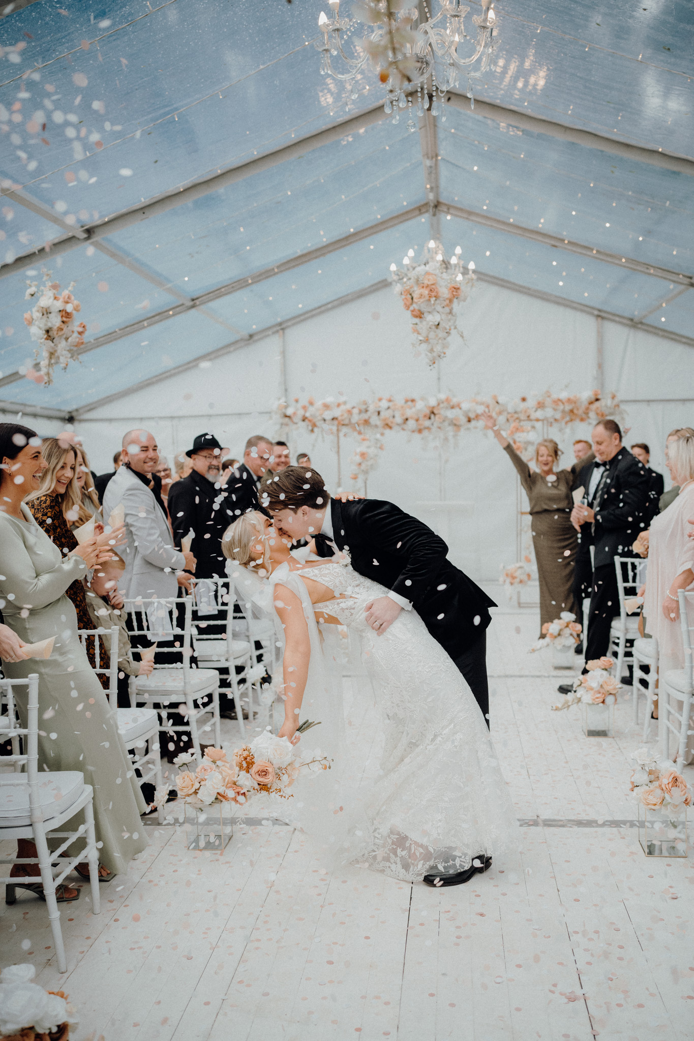 clear marquee - white wall - white floor - chandeliers