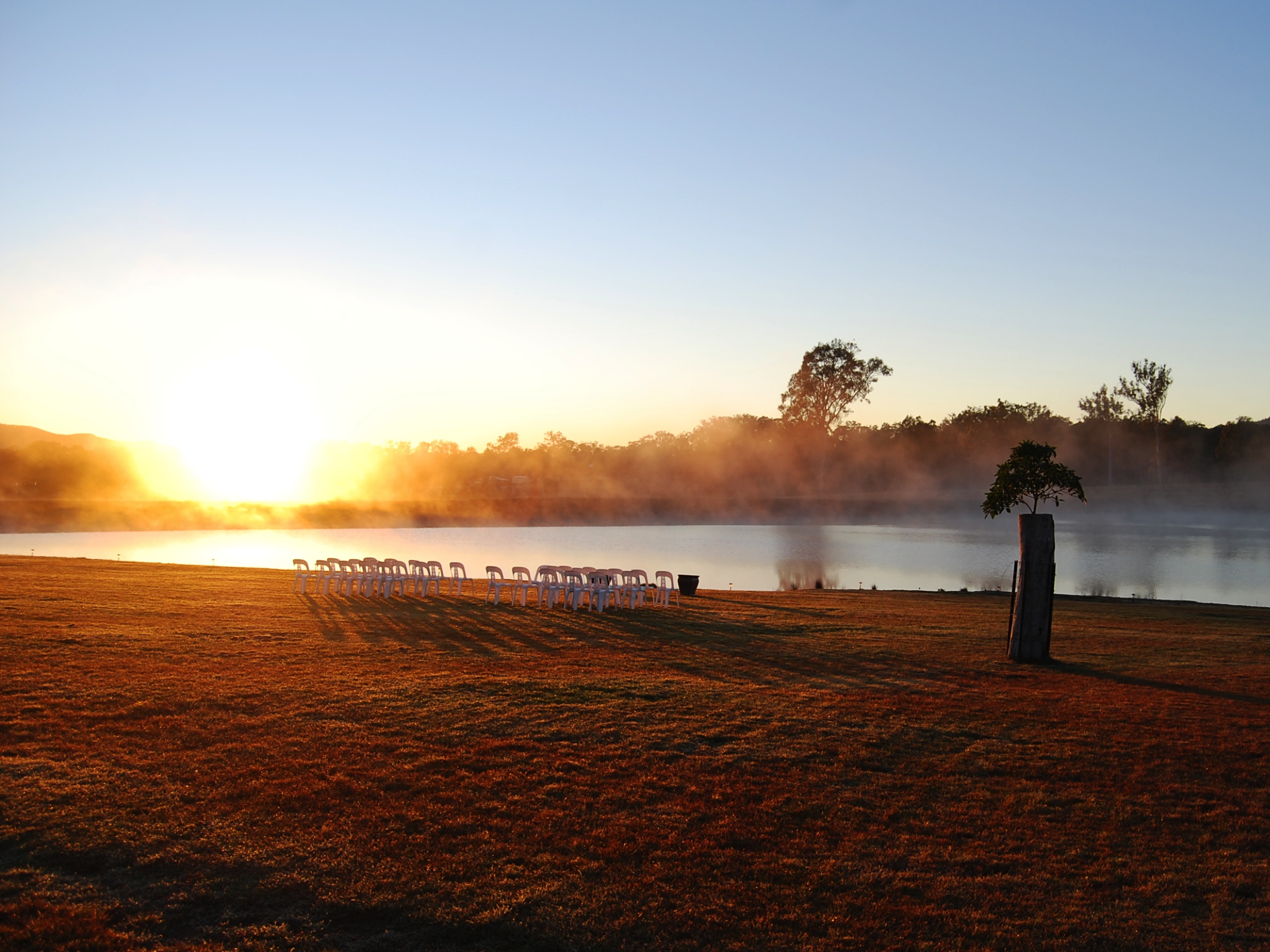 wedding ceremony - lakeside - white padded chairs - americana